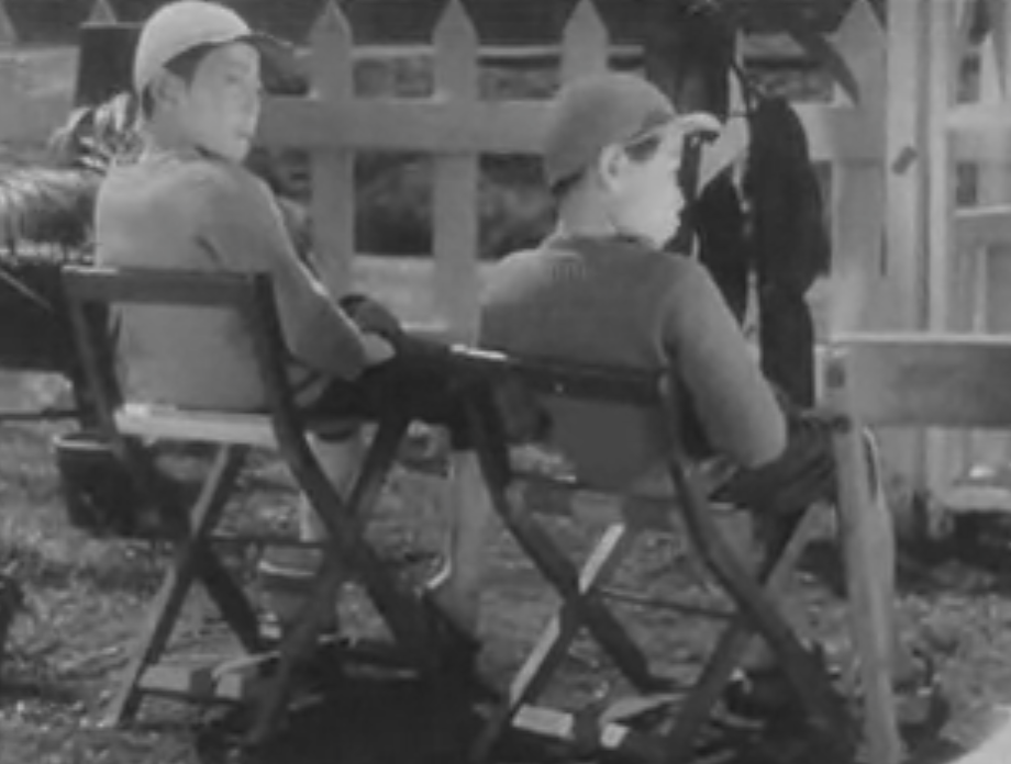 A still image of two boys in chairs from the film "I Was Born, But..."
